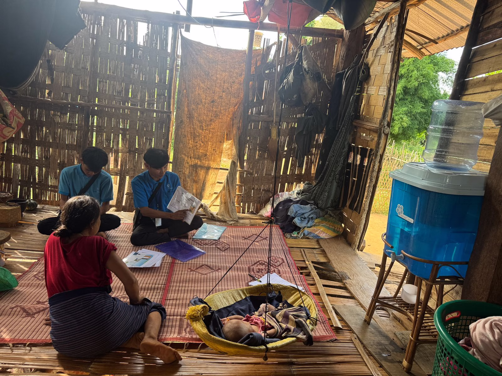 A TerraClear team member visits a family at home to review water safety materials