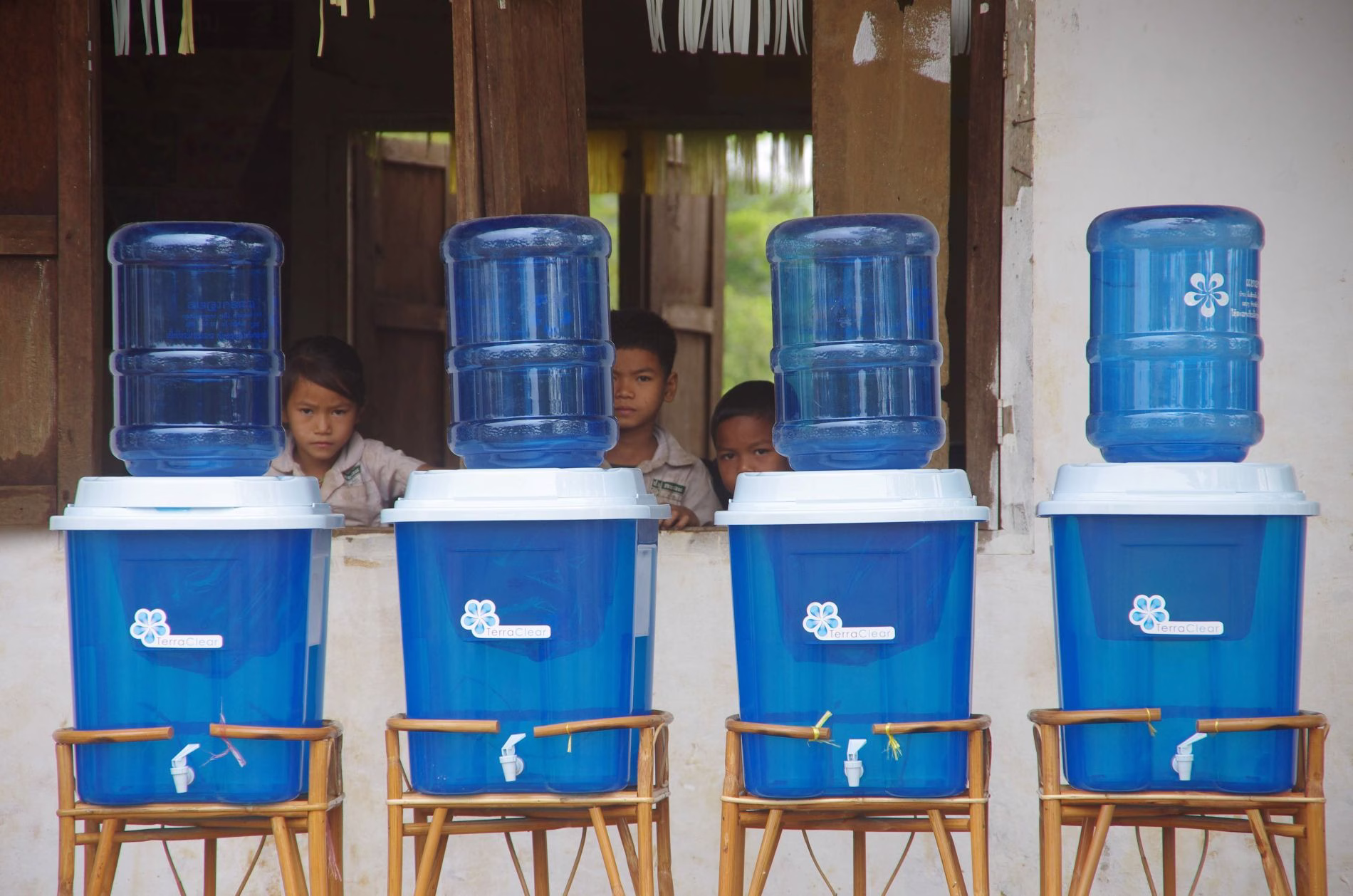 Schoolchildren in front of a school with water filters
